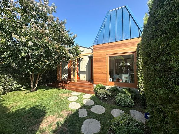 Private front yard, seating area, bay window to office on right