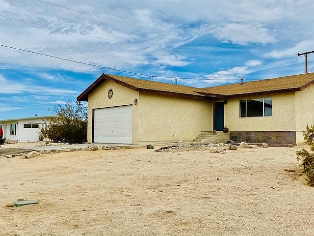 large attached garage with washer and dryer, extra refrigerator and storage space