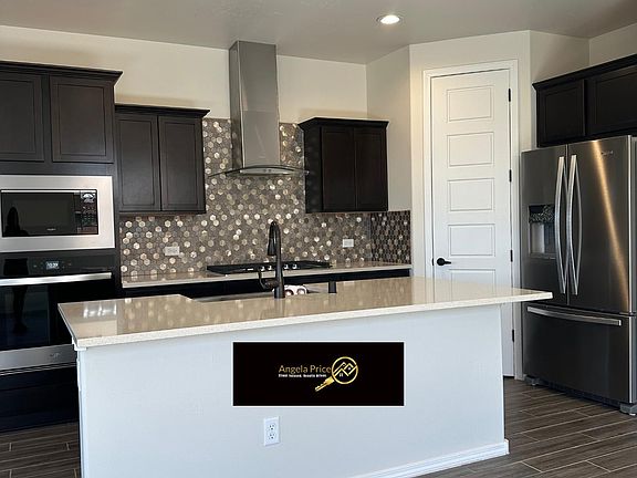 Gourmet Kitchen with Quartz counters, stainless steel appliances and gas range.