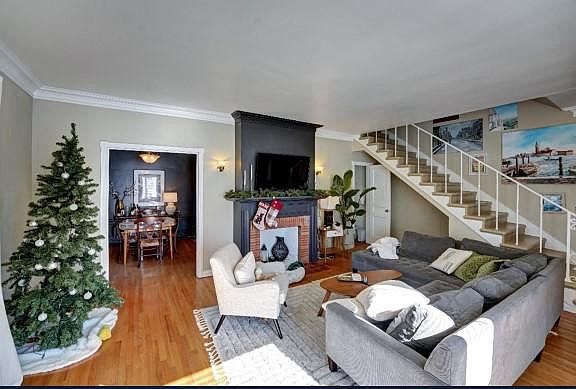 A current tenant living room with a similar layout. High ceilings, original baseboards and the Nomandy charm!