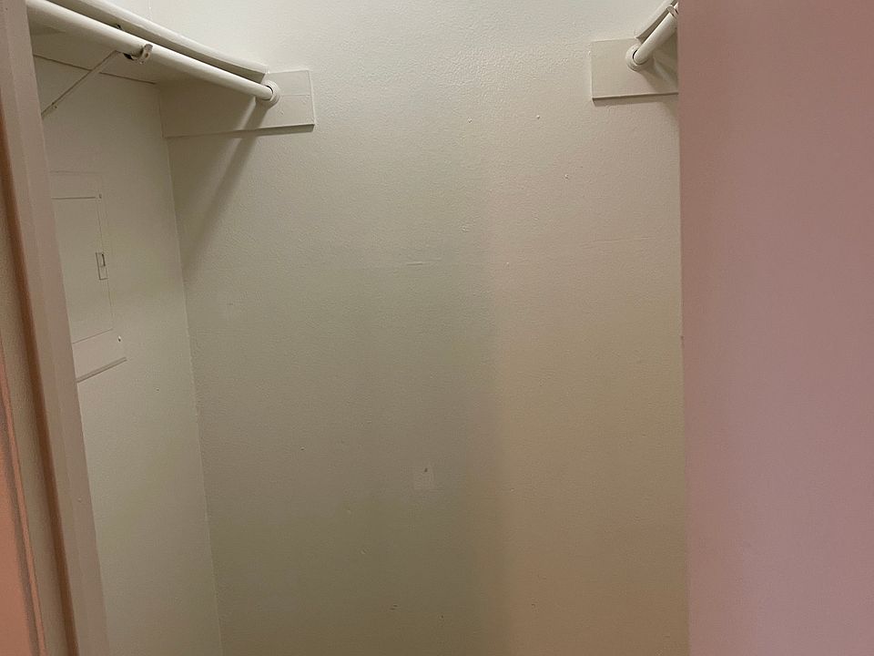 Lighted spacious walk-in closet.