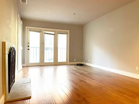 Living room with fire feature and balcony