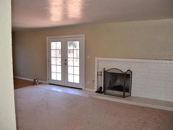 View coming in to living room from front door. Wood fireplace.
