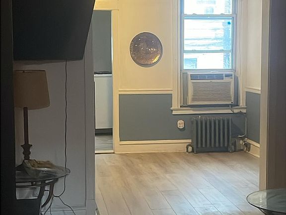 Standing at the front door in the living room looking to the dining room.