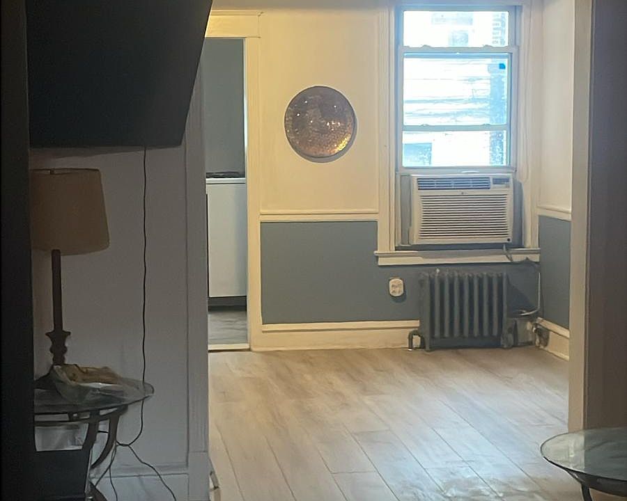 Standing at the front door in the living room looking to the dining room.