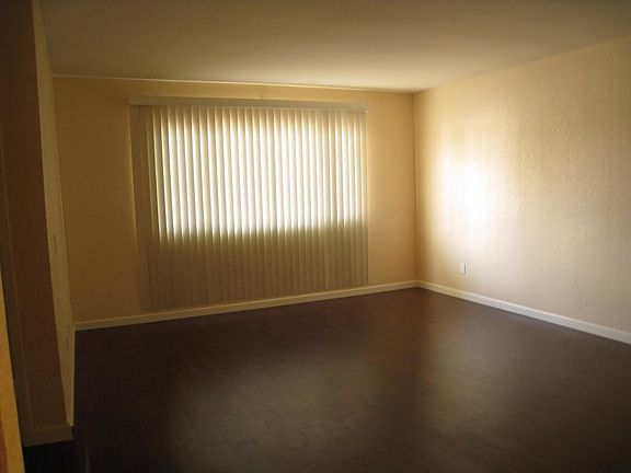 Spacious living room area with view of front yard