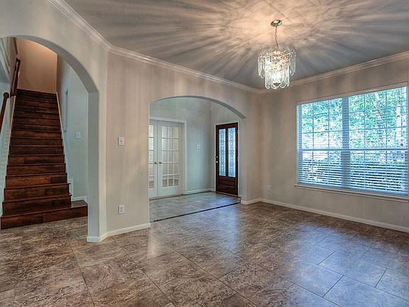 From the formal dining you see wood stairs and doorway to the study.