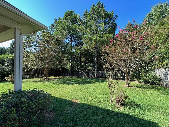 Spacious fenced backyard with covered patio