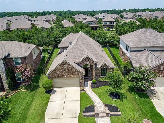 A bird's eye view shows a long driveway that is sure to provide ample parking!