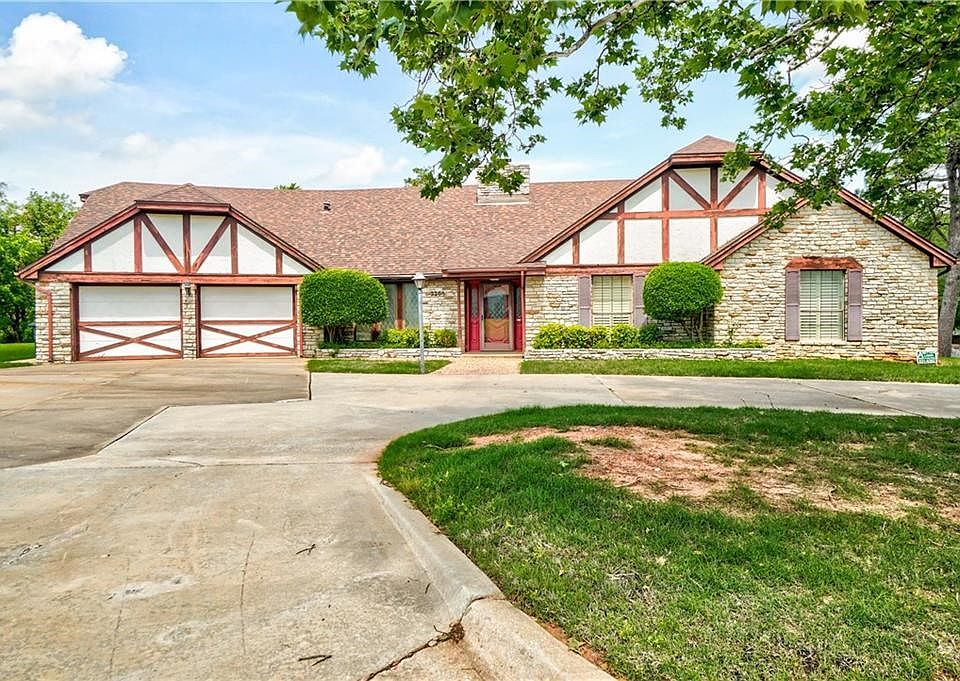 Classic ranch style design with mature trees and circle driveway.