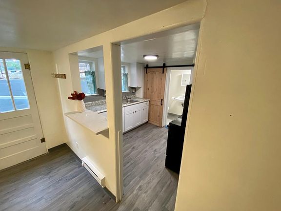 Looking into the kitchen and bathroom from the living area