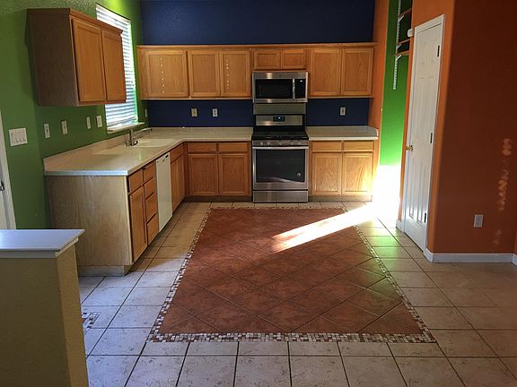 Kitchen with new stainless range and microwave, dishwasher- just needs fridge