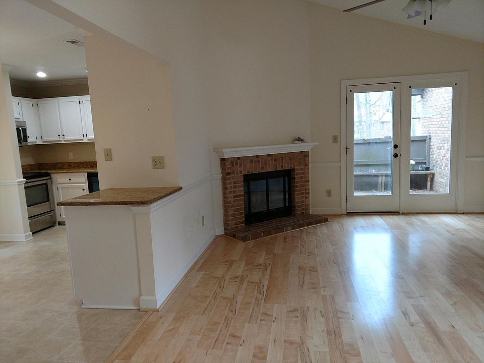 View in living room to kitchen and french doors to deck. Granite countertops in kitchen and master bath.