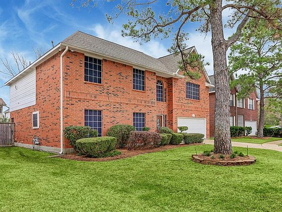 Manicured and well maintained landscaping with mature trees.