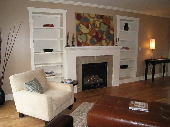 Custom built-in book shelves flank gas burning fireplace