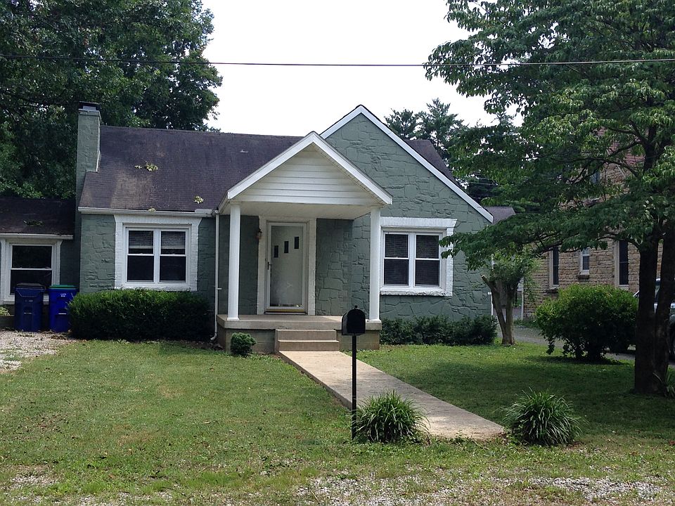 Street view of vintage style rock home