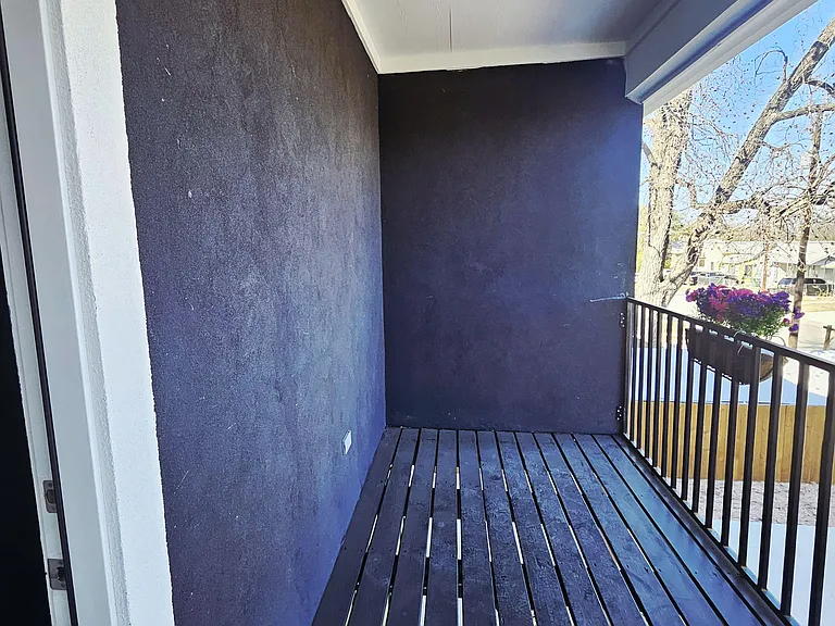Private bedroom 3 balcony with painted decking, overhead light, and railingan easy spot for fresh air and outdoor seating.