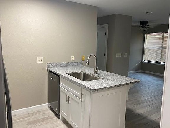 Granite counter tops, dishwasher and deep stainless-steel kitchen sink.
