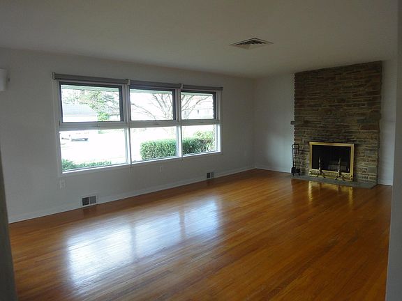 Living room with working fireplace and hardwood floors thru out house