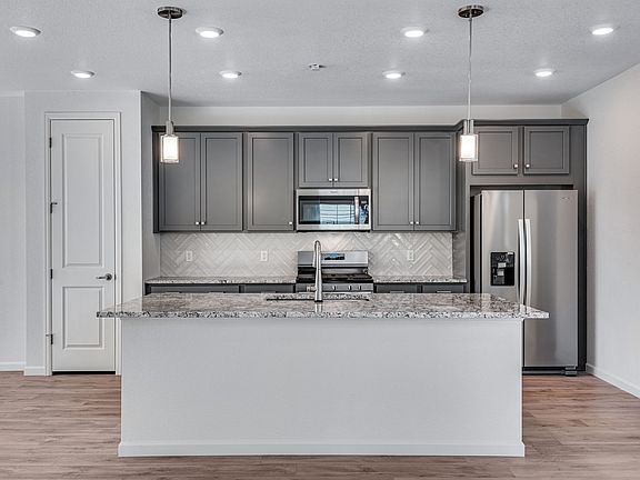A gourmet kitchen with sleek grey cabinetry