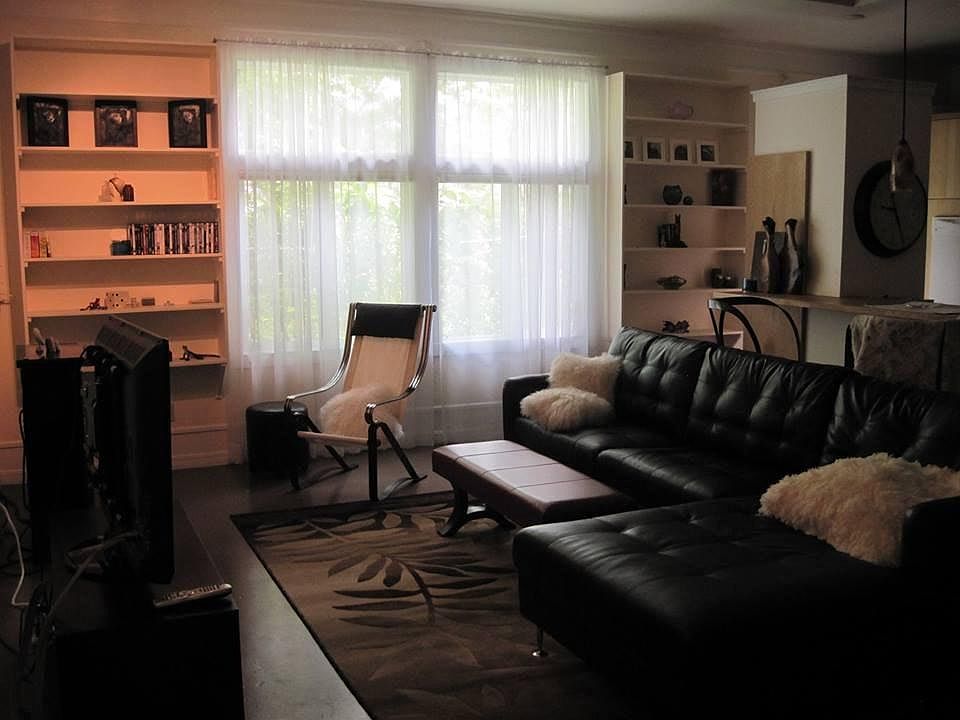 Rug, two bar stools, large sidebar table (matches Ikea kitchen wood), & two floor lamps included in this rental & photo.