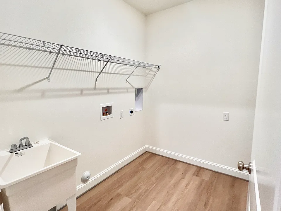 Spacious laundry room with utility sink