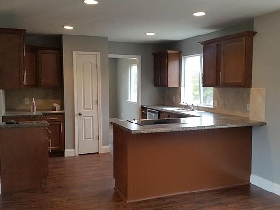 Gorgeous kitchen with breakfast bar. Brand new cabinetry, upgraded stainless appliances, and a beautiful view!
