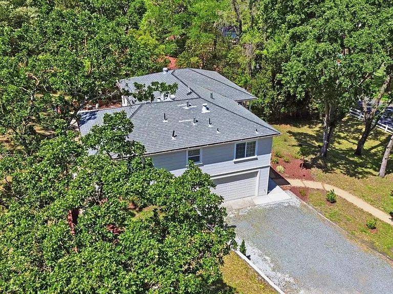 Aerial view showcasing the large lot and natural setting