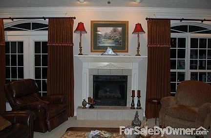 Living Room
						:
						Custom drapes cover 6 foot windows overlooking the back yard. Ceiling fan.