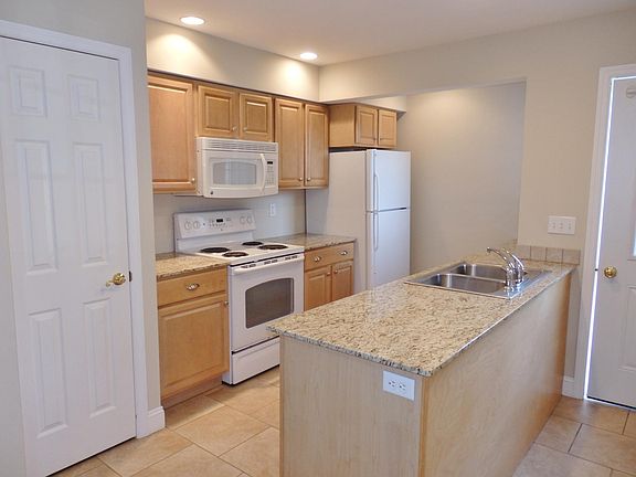 Kitchen with granite counters, GE appliances, coat closet on left side