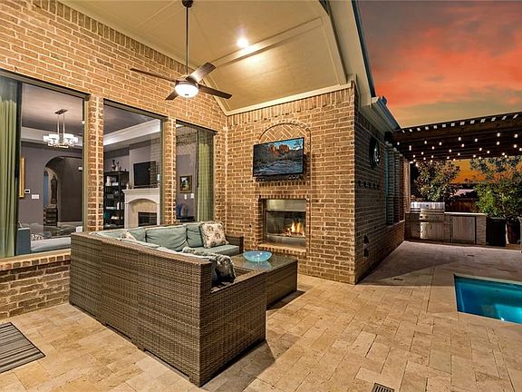 Close up to the large covered patio complete with warm, cozy fireplace and area to watch tv outdoors. Great for football watching parties!