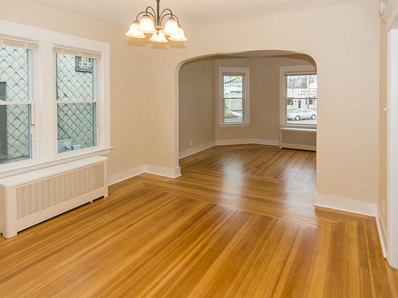 Newly refinished hardwoods in expansive living room and dini