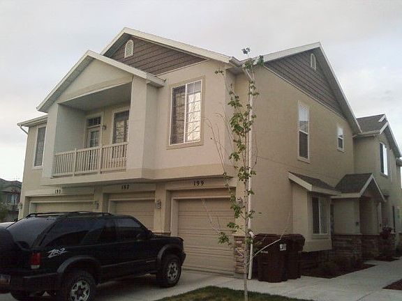 View of balcony,garage, and front door