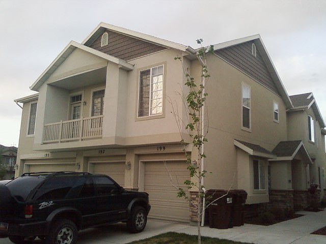 View of balcony,garage, and front door