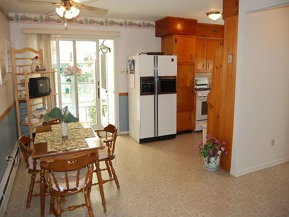 Large eat in kitchen with sliders to screened porch and pool.