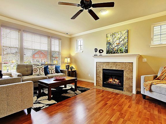 Spacious living room with 9 foot ceilings, gas fireplace and wall of windows for overlooking park for maximium light and sunny exposure.