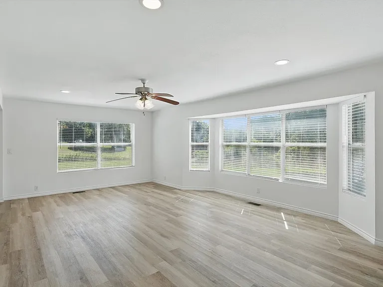 Spare room featuring a ceiling fan, light wood finished floors, baseboards, and recessed lighting