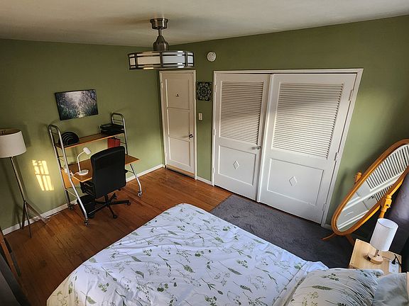 Alt view of available room (shown furnished but can be unfurnished). Ceiling fan/light with remote, wireless charging at desk.