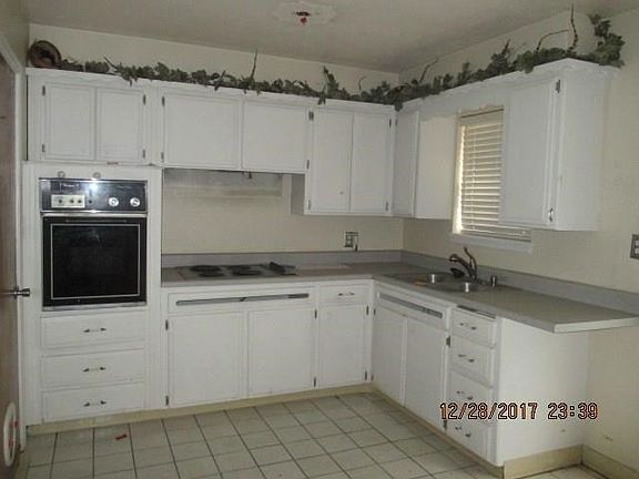 Kitchen features builtin elec range cooktop and builtin oven.