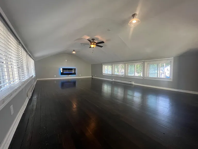 Optional Loft ( Creative / Yoga / Workout / Fun ) space with a Tree-house feel above the garage at $595 / month, includes 20 windows, real Douglas Fir hardwood floors, chic electric fireplace, and Philips Hue smart-lighting.