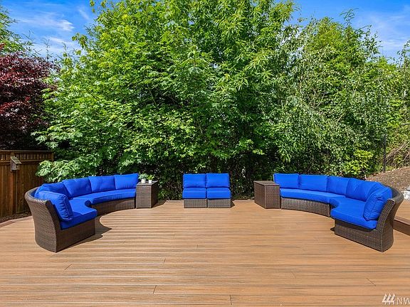 The west and north sides are lined with lush greenery that provide a private back yard. 