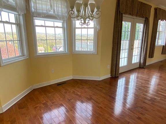 Dinette area by kitchen with doors leading to deck