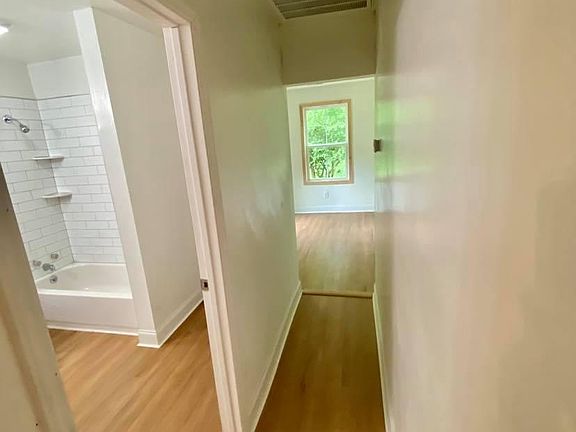 Hall way from living room to back bedrooms, bathroom off of hall