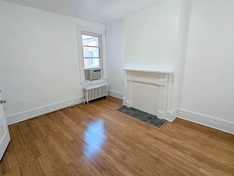 2nd Floor Middle Bedroom a window overlooking the garden, a good sized closet, warm hearth/fireplace, and natural light