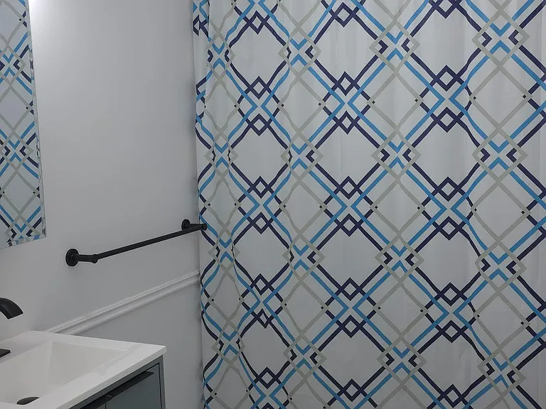 Updated bath with tiled shower surround, sleek vanity, and easy-care tile flooring for everyday convenience.