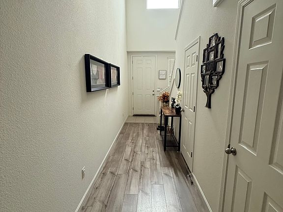Long hall entry way with 1/2 bath and closet space.