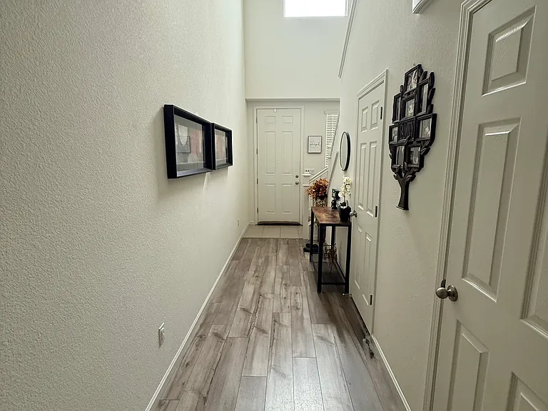 Long hall entry way with 1/2 bath and closet space.