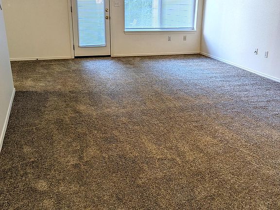 Living space with access to back patio and storage.