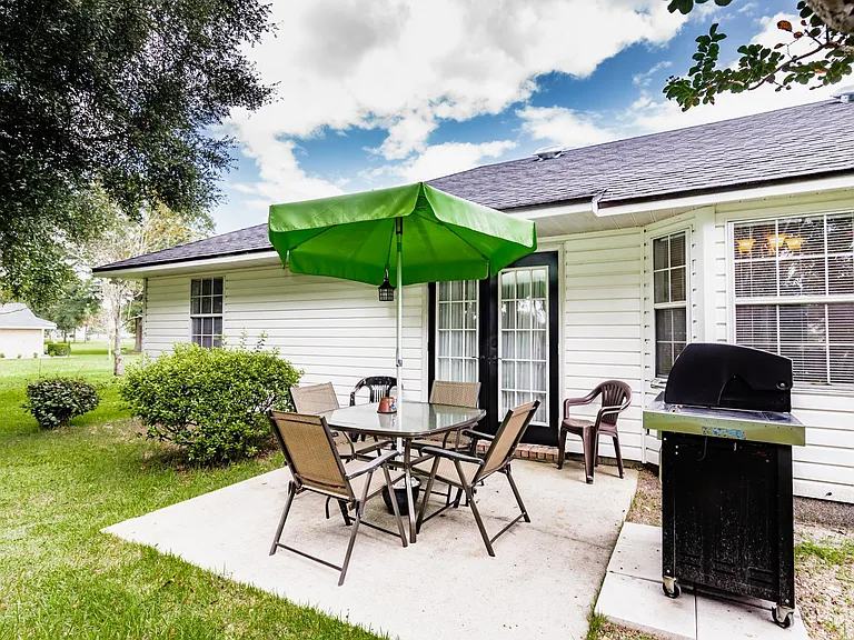 Small patio with 8 chairs and table. Propane grill.