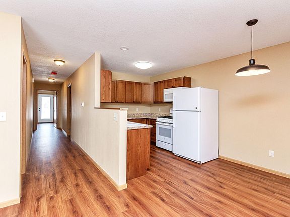 Kitchen, dining area and view down the hallway. Some units have carpet in hallway and bedrooms.